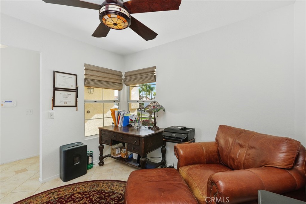 25644 Pelion Road Menifee, CA 92584 - Photo 13 of 26 a living room with furniture a rug and a chandelier