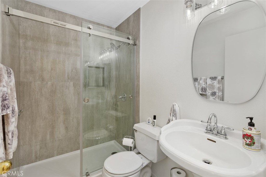 25644 Pelion Road Menifee, CA 92584 - Photo 17 of 26 a bathroom with a sink toilet and shower