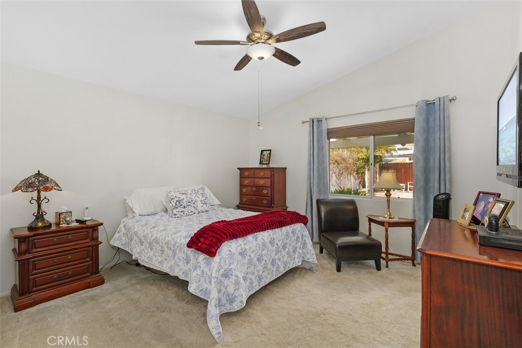 25644 Pelion Road Menifee, CA 92584 - Photo 18 of 26 a bedroom with a bed and a chandelier