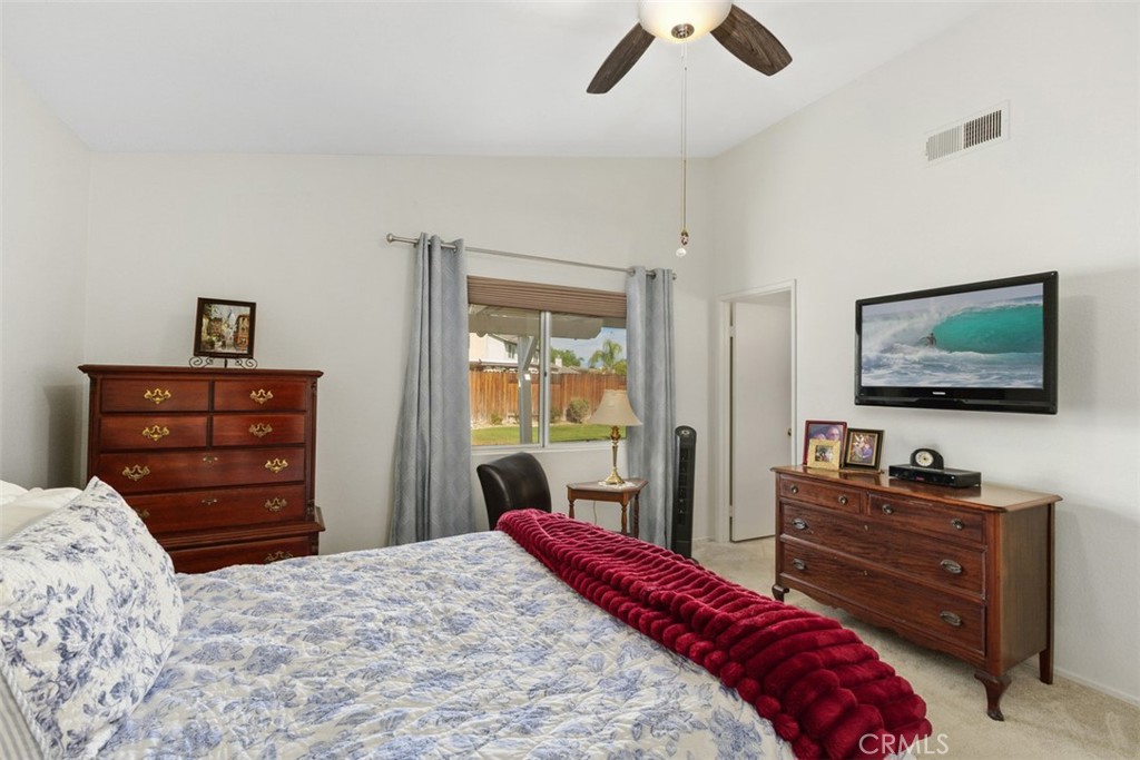 25644 Pelion Road Menifee, CA 92584 - Photo 19 of 26 a bedroom with a bed and flat screen tv