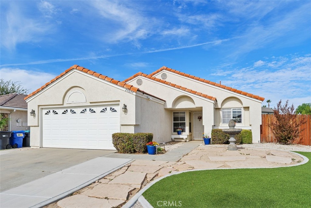 25644 Pelion Road Menifee, CA 92584 - Photo 3 of 26 a view of a white house with a big yard and large trees