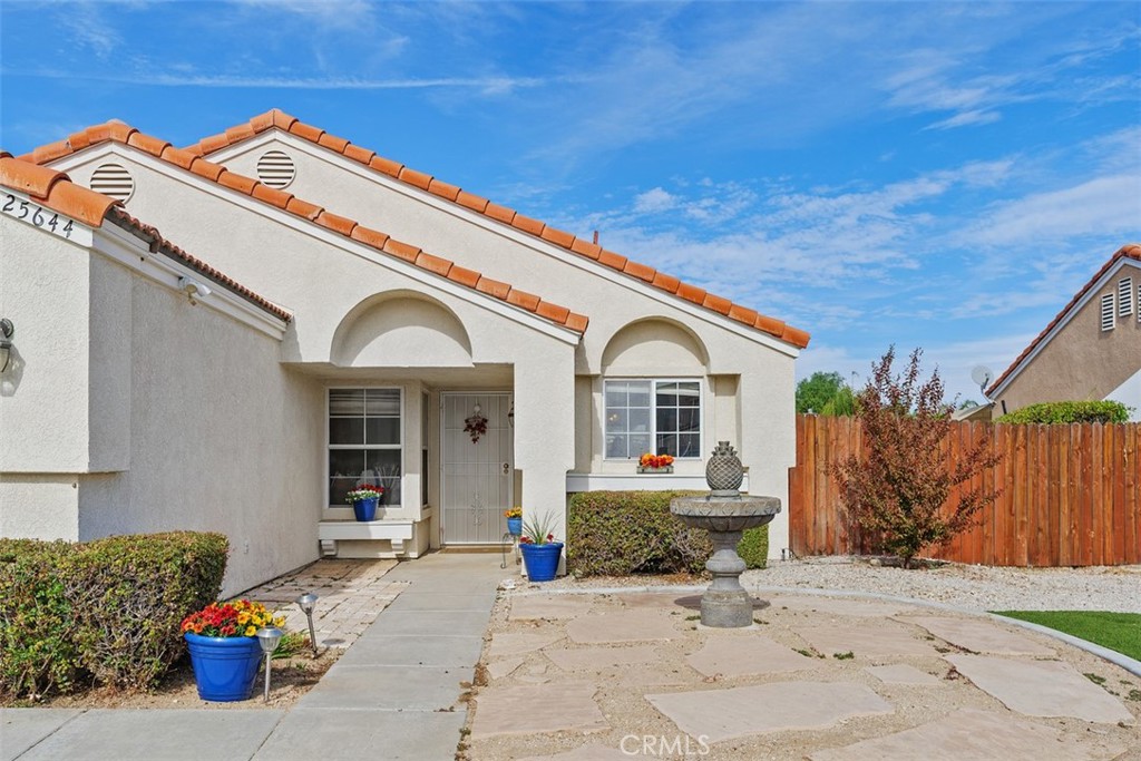 25644 Pelion Road Menifee, CA 92584 - Photo 4 of 26 a view of a white house with a outdoor space