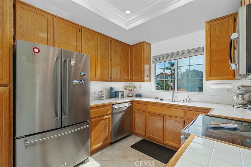 25644 Pelion Road Menifee, CA 92584 - Photo 9 of 26 a kitchen with a sink a refrigerator and cabinets