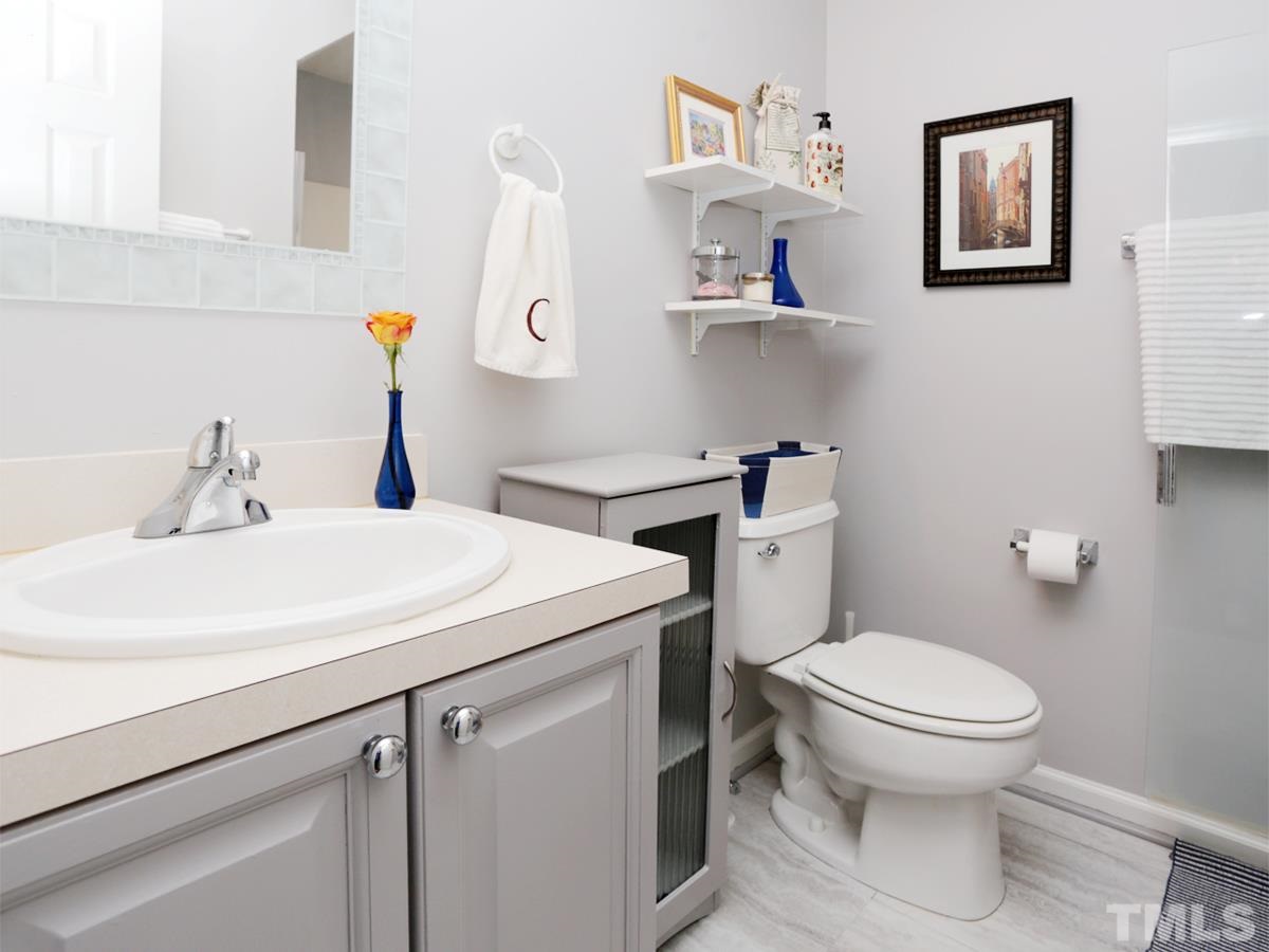 2025 Persimmon Ridge Drive Raleigh, NC 27604 - Photo 13 of 19 a bathroom with a sink toilet and a mirror