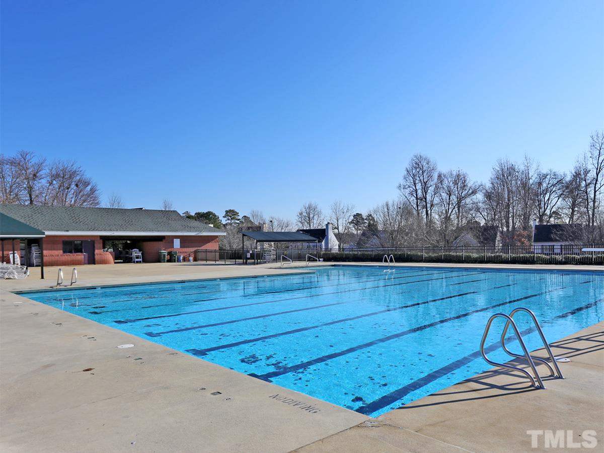 2025 Persimmon Ridge Drive Raleigh, NC 27604 - Photo 18 of 19 a view of swimming pool with outdoor seating and yard in the back