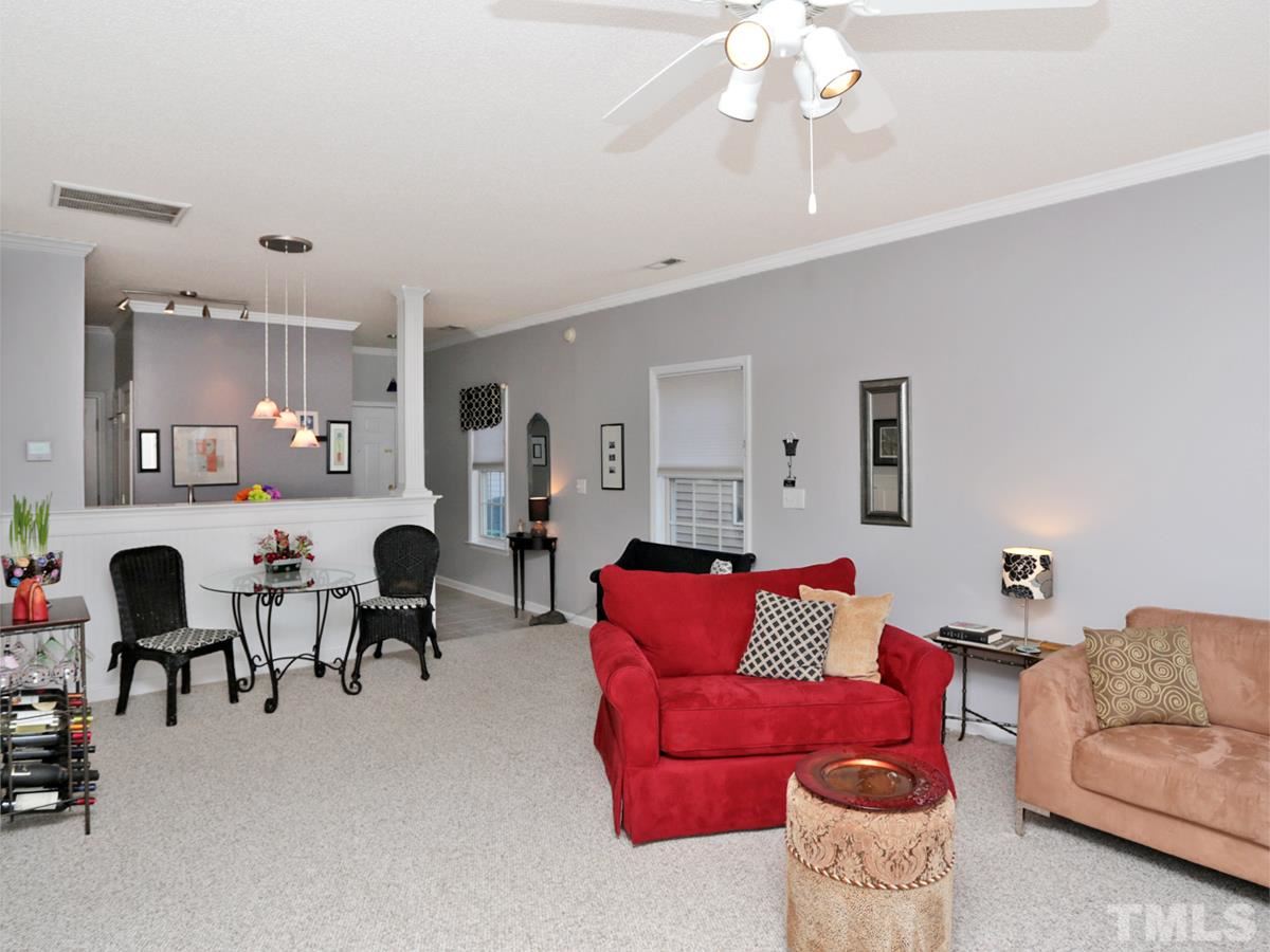2025 Persimmon Ridge Drive Raleigh, NC 27604 - Photo 3 of 19 a living room with furniture and kitchen chandelier