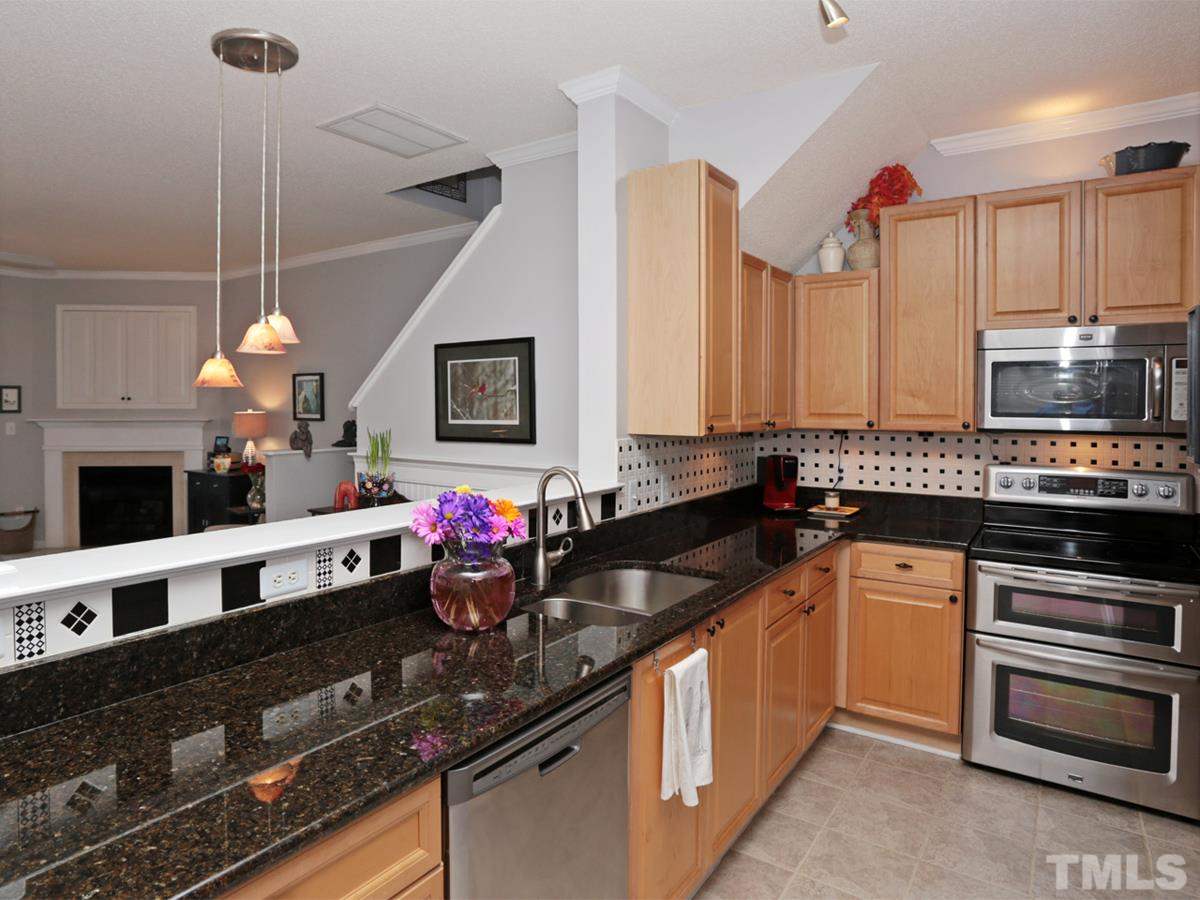 2025 Persimmon Ridge Drive Raleigh, NC 27604 - Photo 5 of 19 a kitchen with stainless steel appliances granite countertop a sink a stove and a microwave