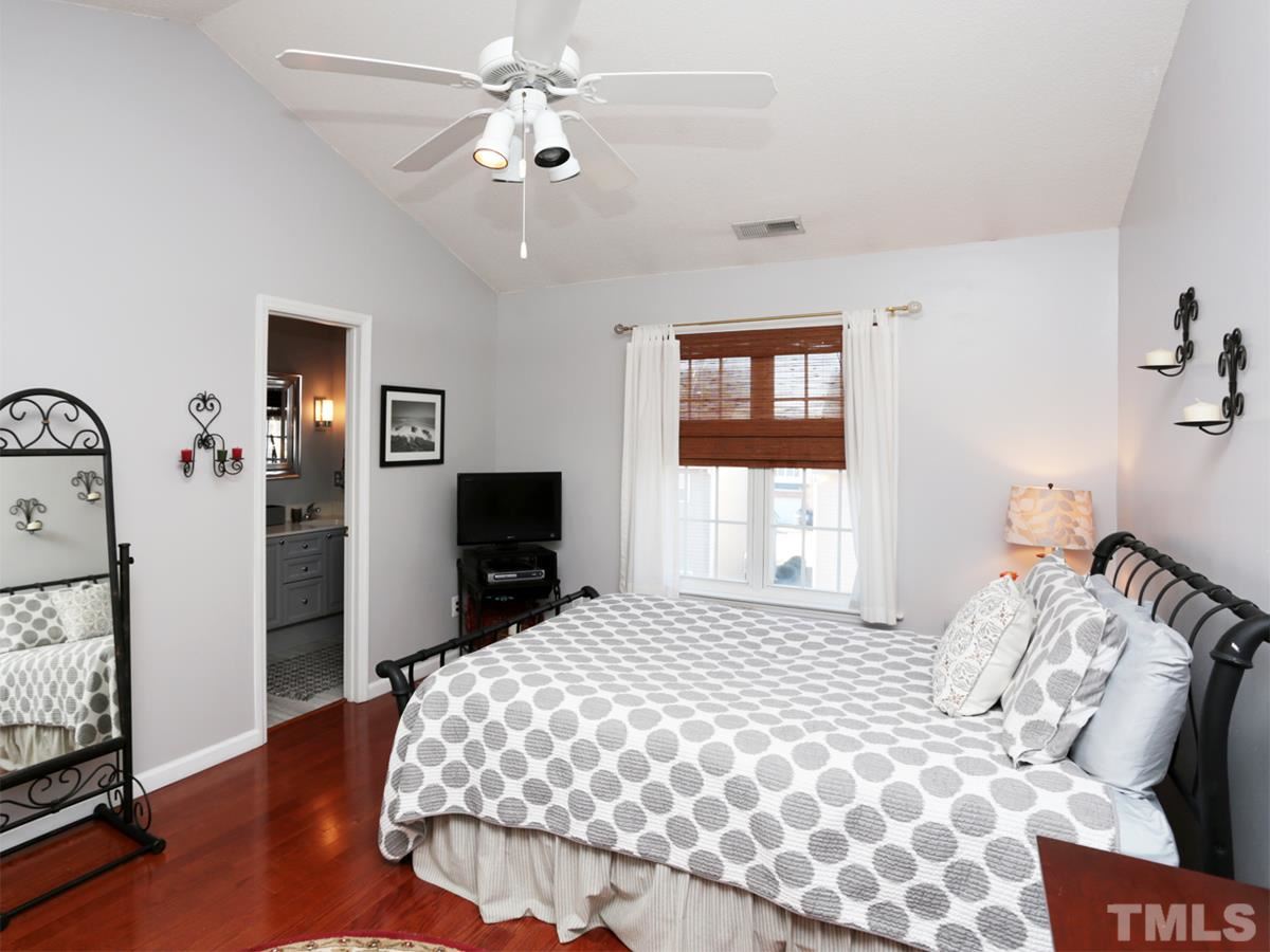 2025 Persimmon Ridge Drive Raleigh, NC 27604 - Photo 9 of 19 a bedroom with a bed and a flat screen tv