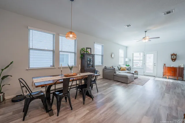 a view of a dining room with furniture window and wooden floor