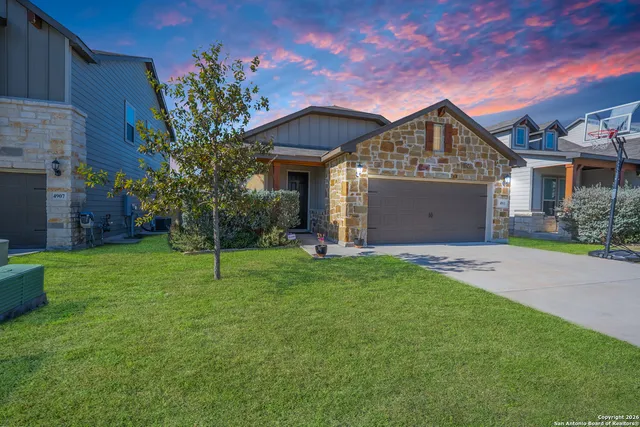 a front view of house with a garden
