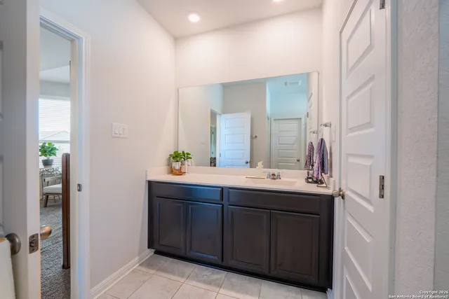 a bathroom with a double vanity sink and a mirror