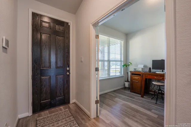 a view of a workspace with furniture and window