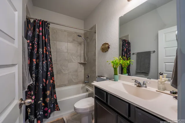 a bathroom with a sink toilet tub and shower