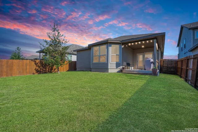 an aerial view of a house with a yard