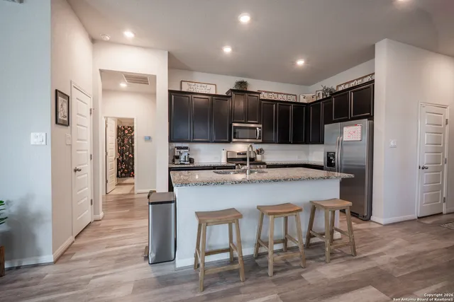 a kitchen with stainless steel appliances a sink stove and refrigerator