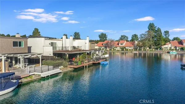 a view of a lake with boats and buildings in the background