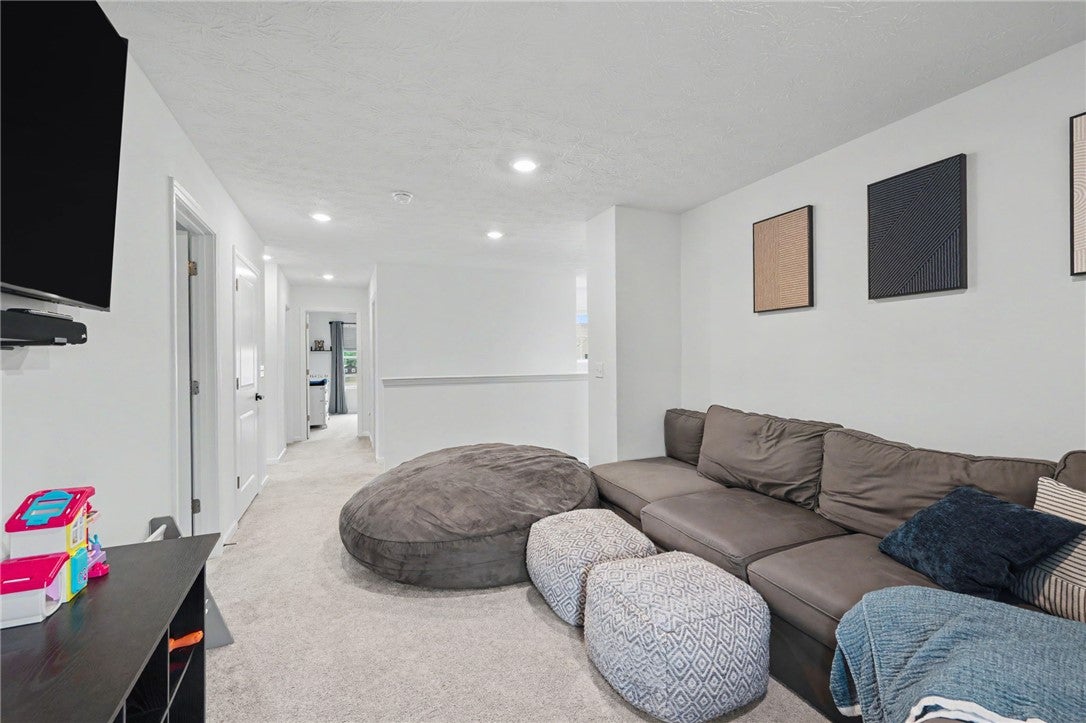 3011 Falls Road Clayton, OH 45315 - Photo 34 of 66 Well-lit living space with recessed lighting and soft carpeting provides a comfortable atmosphere.