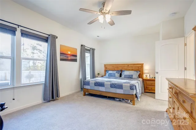 a spacious bedroom with a bed and a window