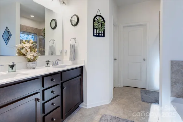 a bathroom with a double vanity sink and a mirror