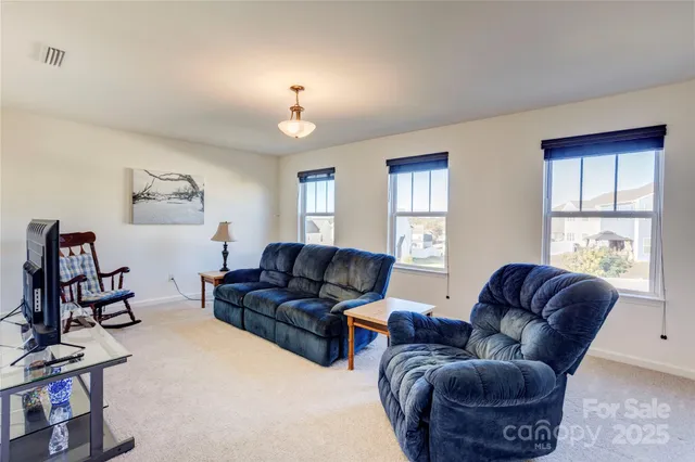 a living room with furniture fireplace and window