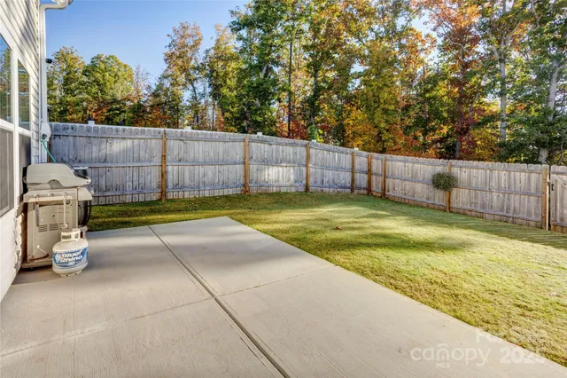 a view of a backyard with swimming pool