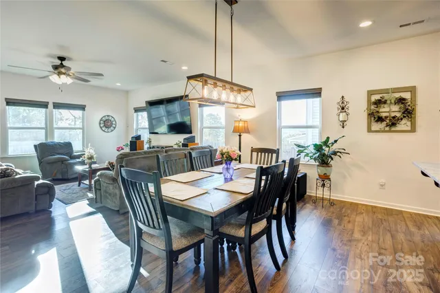 a view of a a dining room with furniture window and wooden floor