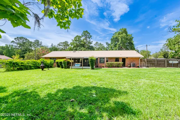 a view of a park with two large trees