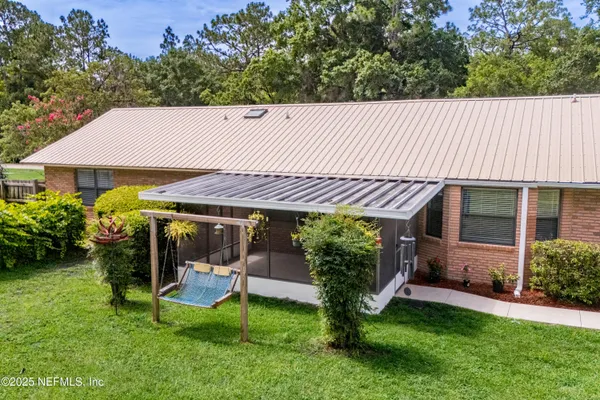 a view of an empty room with large windows