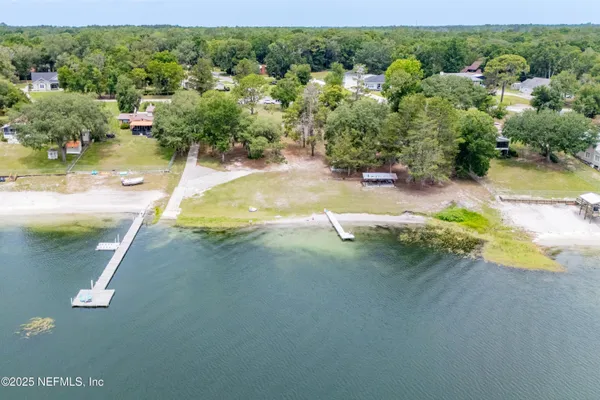 a view of a wooden house with a yard