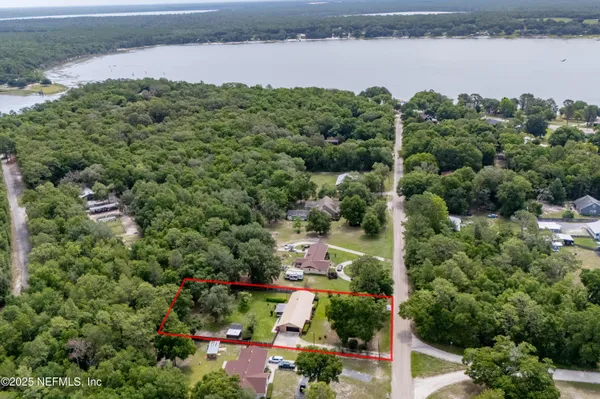 a kitchen with a sink a stove top oven and white cabinets