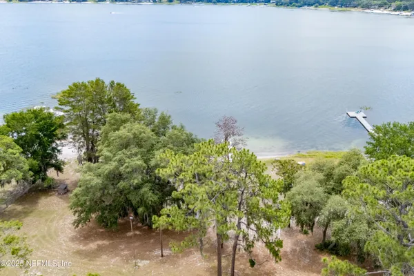 an aerial view of residential houses with outdoor space and swimming pool