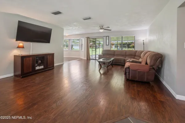 a view of a hallway with wooden floor