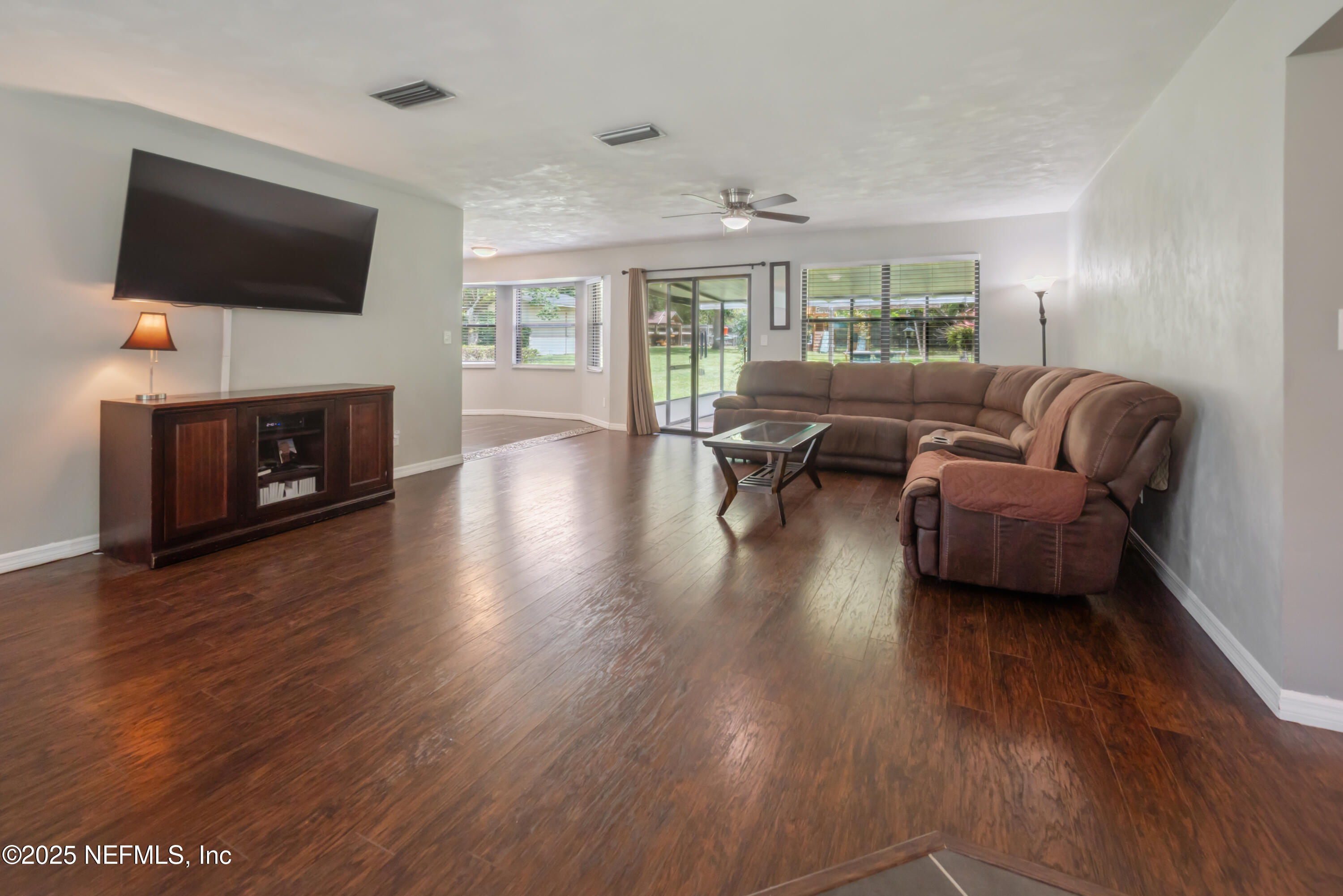 363 Southeast 73rd Street Starke, FL 32091 - Photo 31 of 49 a living room with fireplace furniture and a flat screen tv
