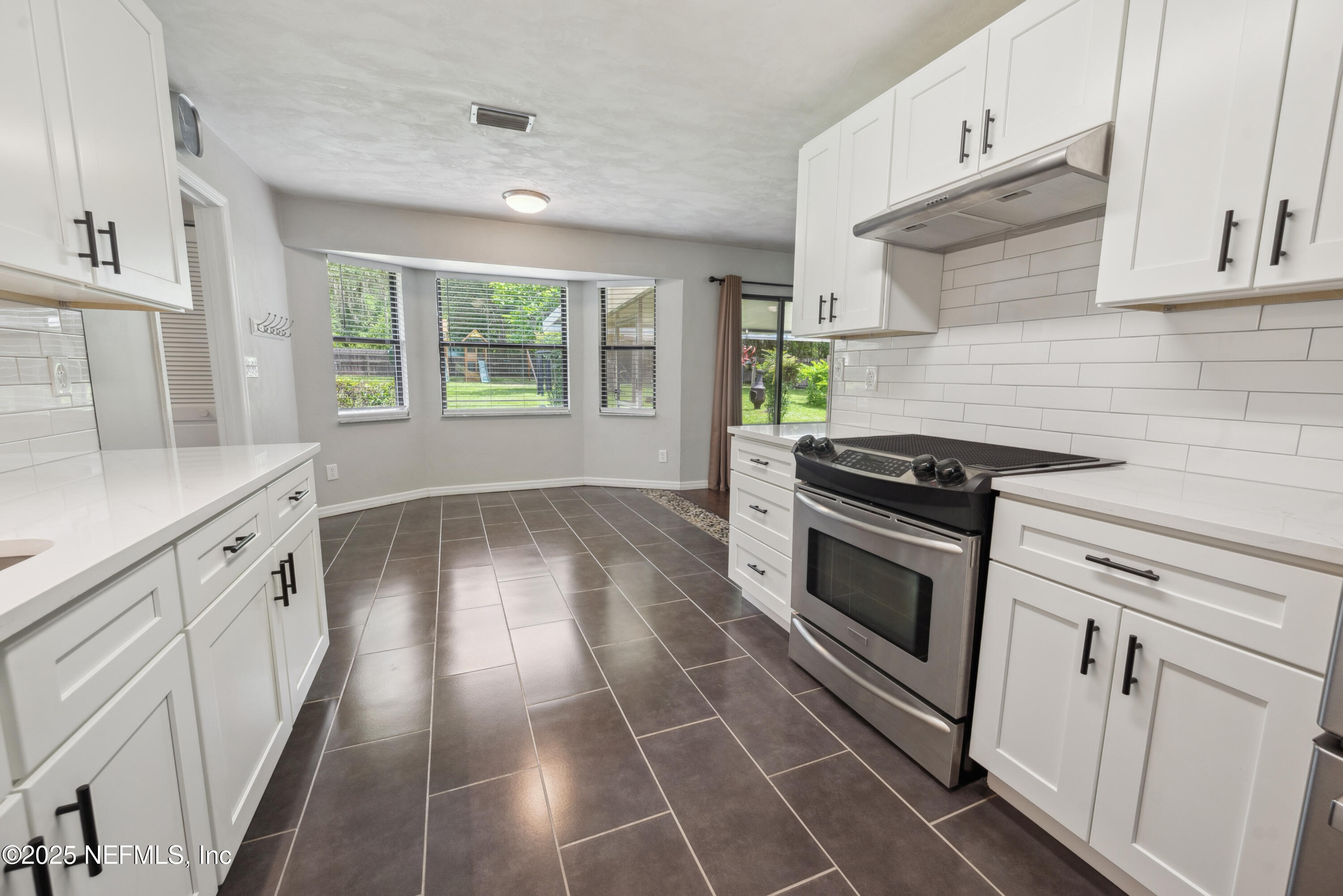 363 Southeast 73rd Street Starke, FL 32091 - Photo 38 of 49 a kitchen with granite countertop a stove a sink and a refrigerator