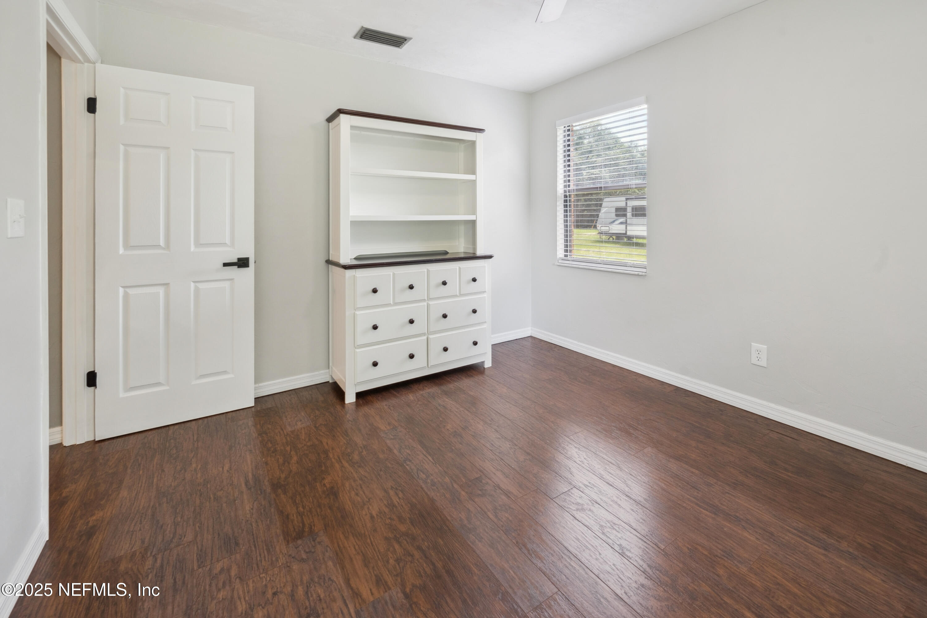 363 Southeast 73rd Street Starke, FL 32091 - Photo 46 of 49 an empty room with wooden floor closet and windows
