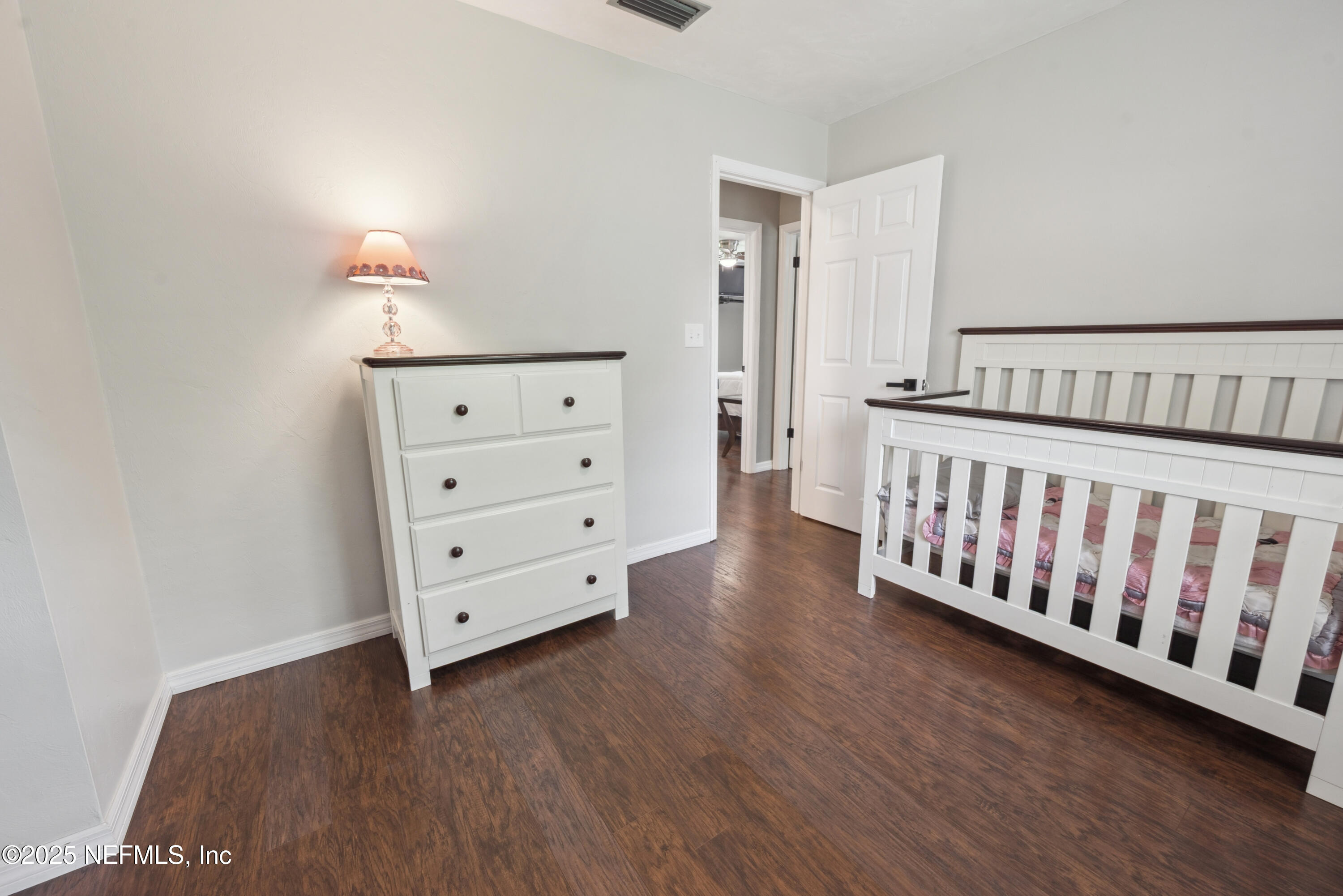 363 Southeast 73rd Street Starke, FL 32091 - Photo 47 of 49 a bedroom with a bed and wooden floor
