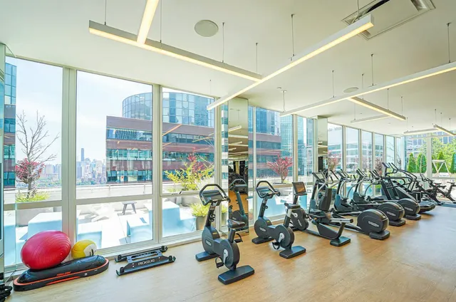 a living room with furniture a chandelier and a large window