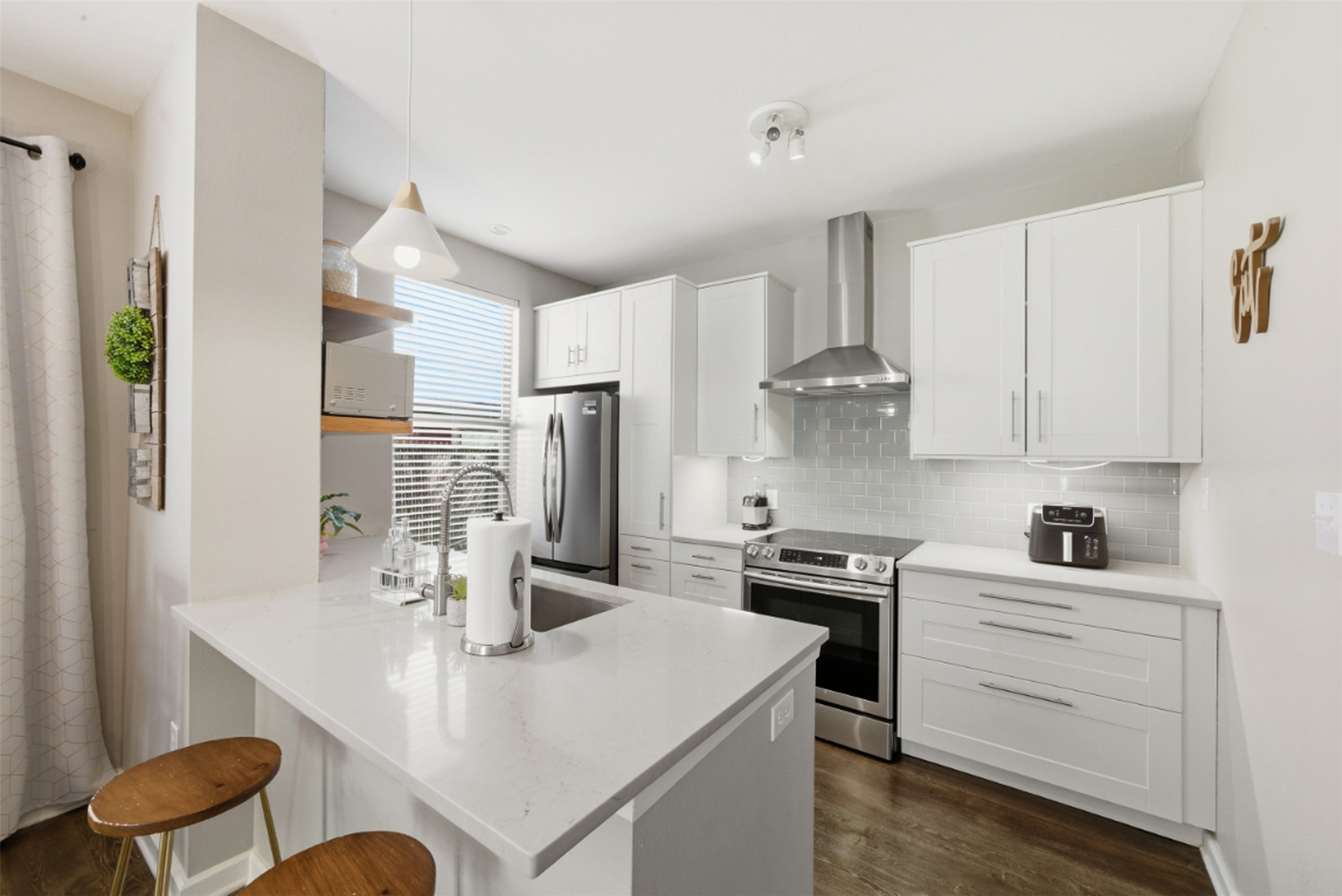 1201 Grove Boulevard, Unit 1304 Austin, TX 78741 - Photo 6 of 19 a kitchen with white cabinets and stainless steel appliances
