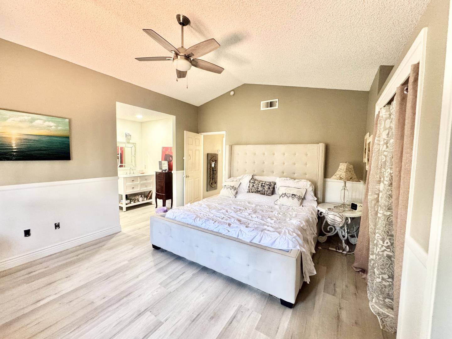7605 Golden Rise Court Bakersfield, CA 93313 - Photo 12 of 16 a spacious bedroom with a bed and a flat screen tv