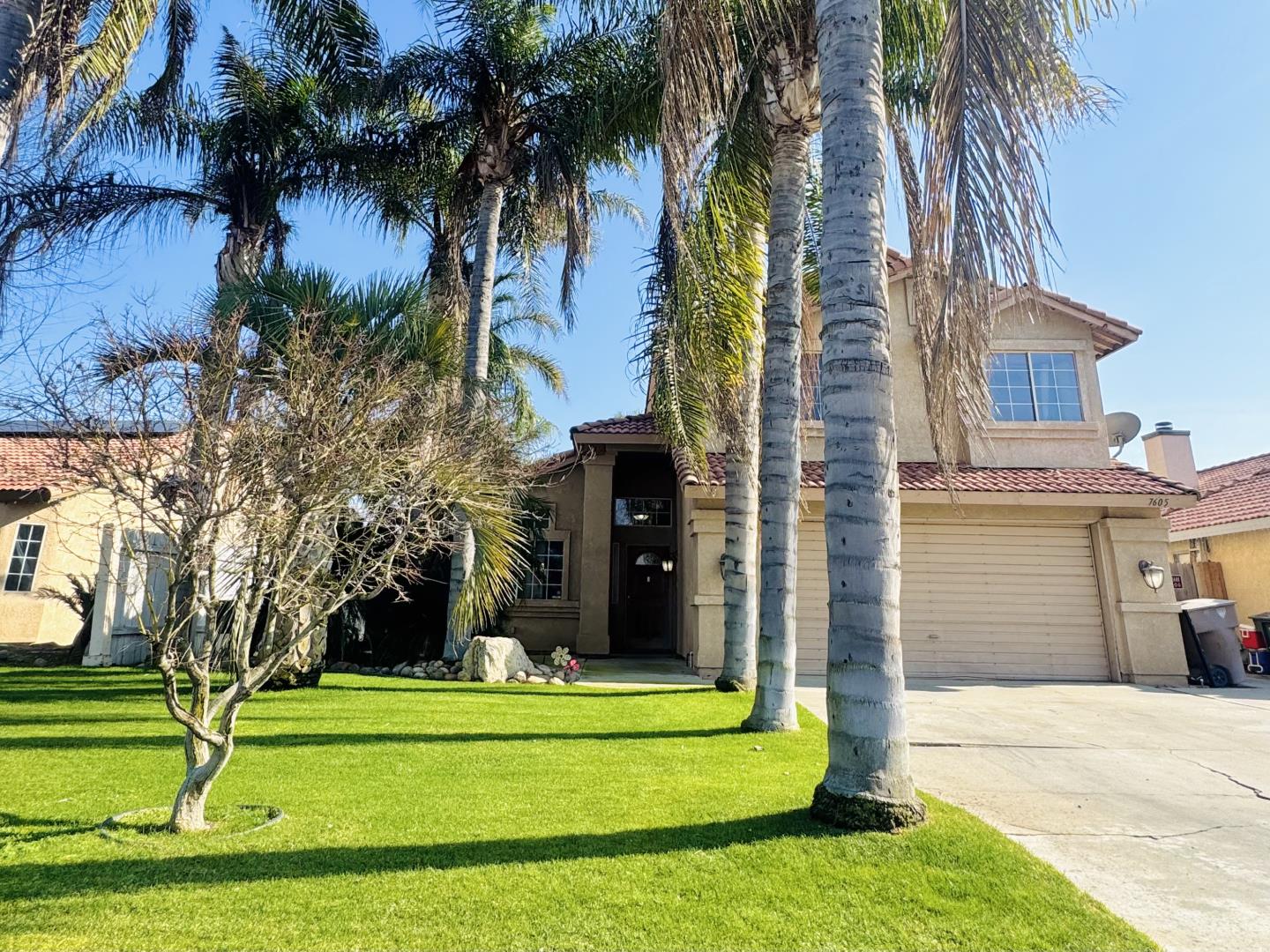 7605 Golden Rise Court Bakersfield, CA 93313 - Photo 2 of 16 a front view of a house with a garden and trees