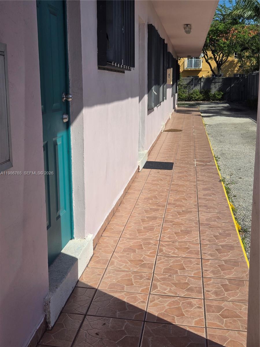 15 West 9th Street, Unit 3 Hialeah, FL 33010 - Photo 3 of 9 a view of a pathway both side of building