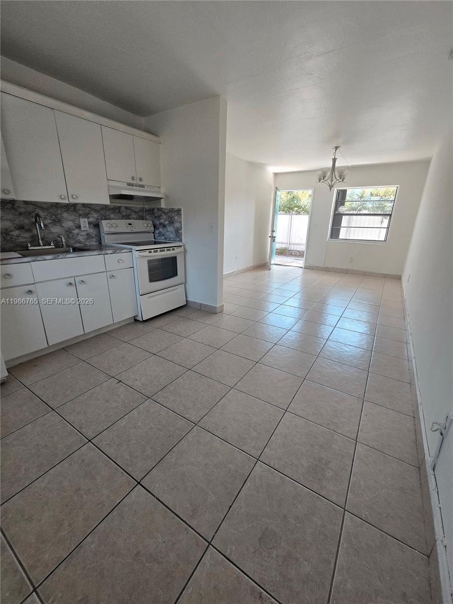 15 West 9th Street, Unit 3 Hialeah, FL 33010 - Photo 5 of 9 a kitchen with stainless steel appliances a sink stove and cabinets