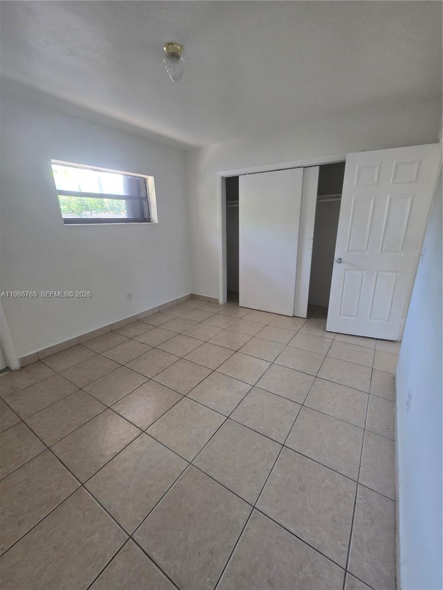 15 West 9th Street, Unit 3 Hialeah, FL 33010 - Photo 7 of 9 a view of an empty room and window