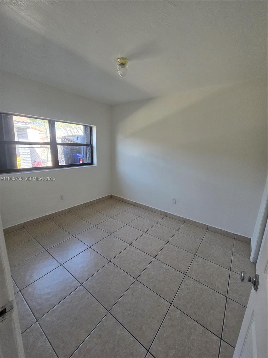 15 West 9th Street, Unit 3 Hialeah, FL 33010 - Photo 8 of 9 an empty room with windows