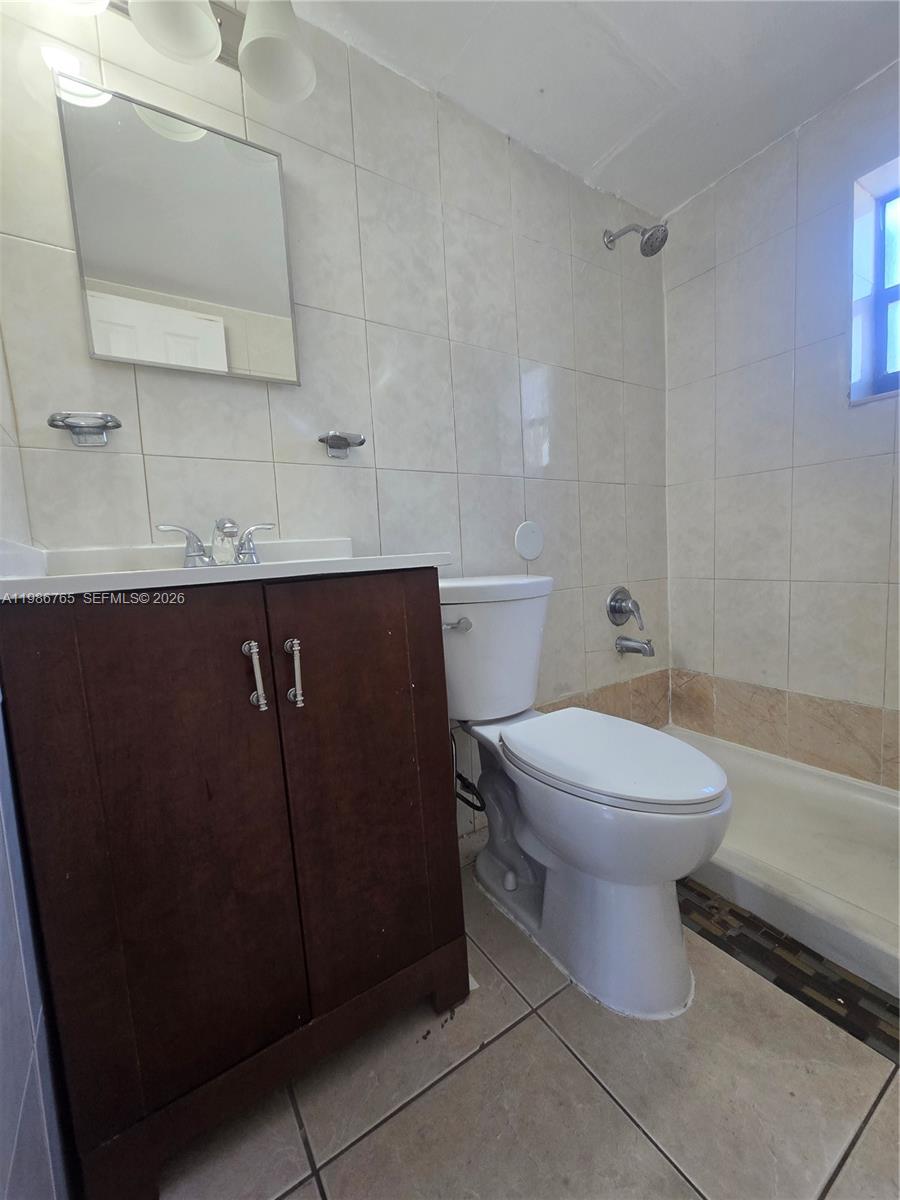 15 West 9th Street, Unit 3 Hialeah, FL 33010 - Photo 9 of 9 a bathroom with a toilet a sink and bathtub