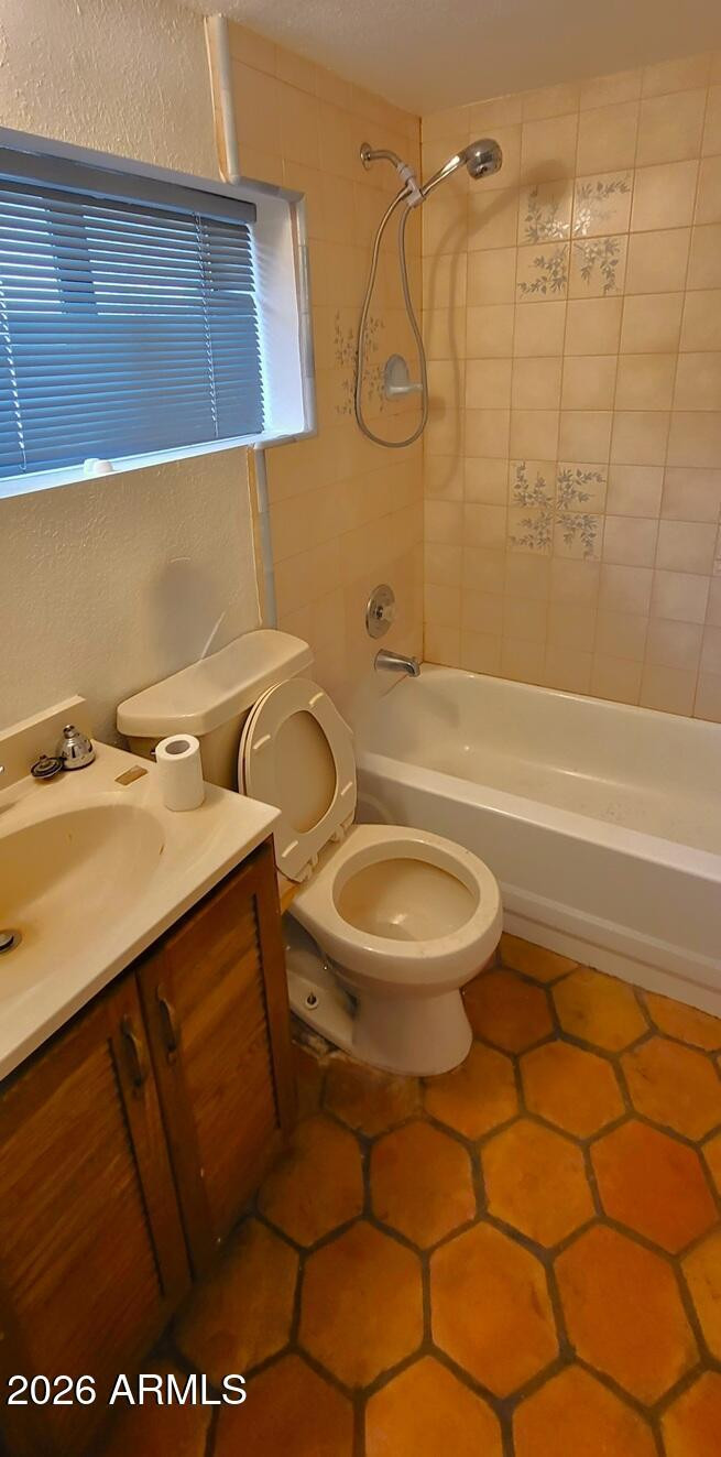 1125 South Stratton Lane Tempe, AZ 85281 - Photo 2 of 10 a bathroom with a sink a toilet and shower