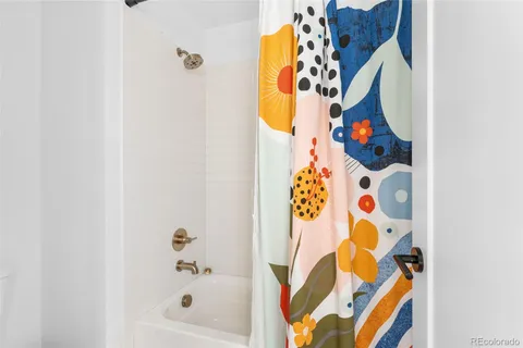 a bathroom with a bathtub and a shower curtain