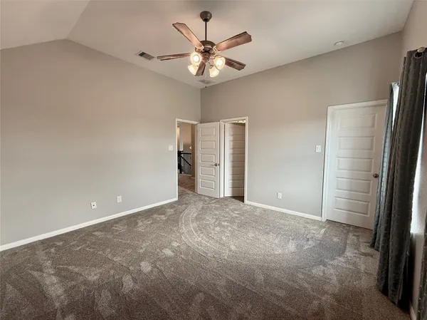 a view of a livingroom with a ceiling fan and window