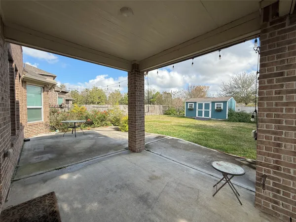 a view of a porch with furniture and garden