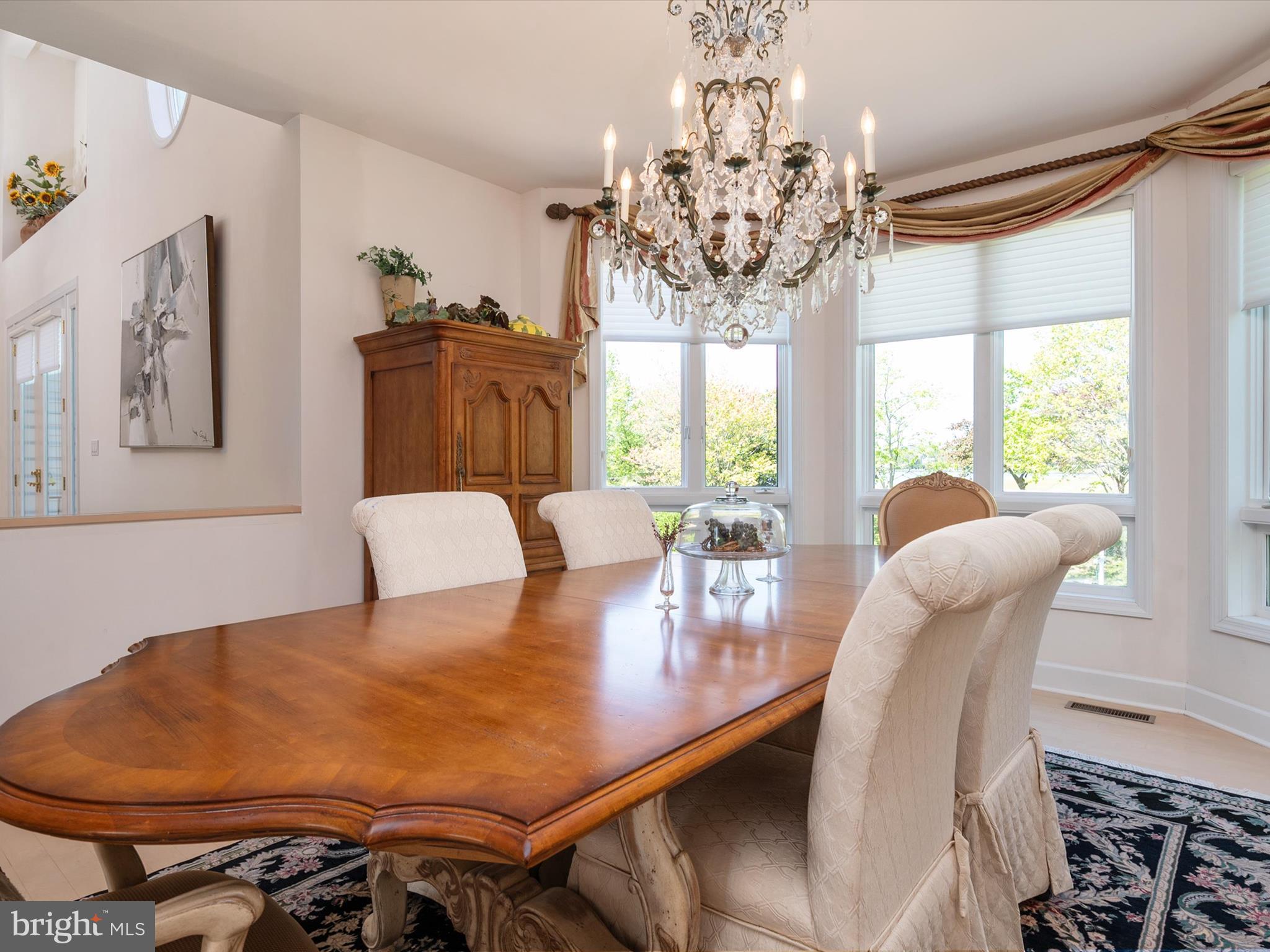 1237 Cherry Tree Lane Annapolis, MD 21403 - Photo 26 of 86 a view of a dining room with furniture a chandelier and wooden floor